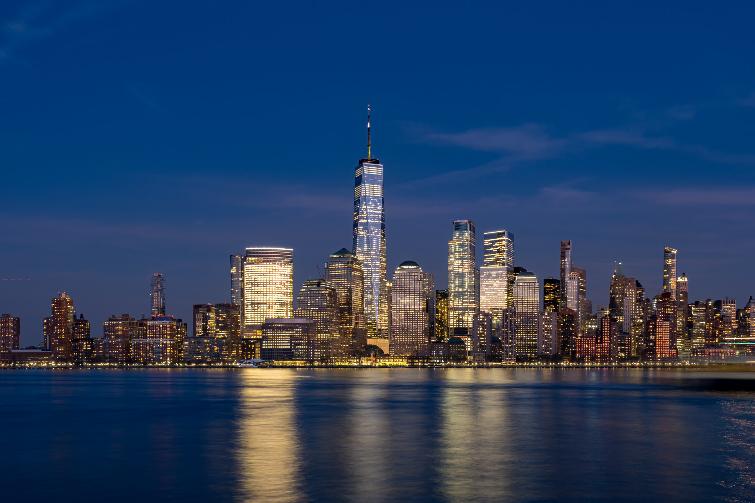 night view of clouds moving over buildings in lower manhattan financial district hudson river